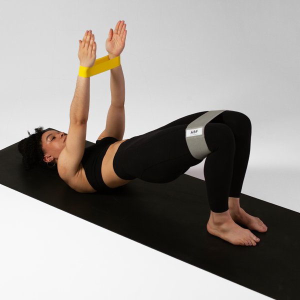 Woman using ABF branded resistance bands