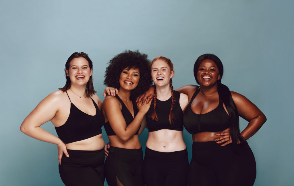Portrait,Of,Group,Of,Women,Posing,Together,In,Sportswear,Against