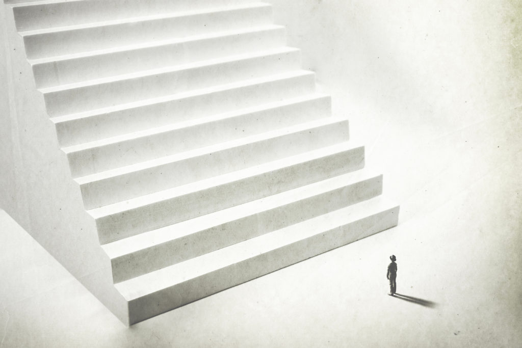Beginning,A,New,Challenge,,Man,Climbing,Big,White,Stairs