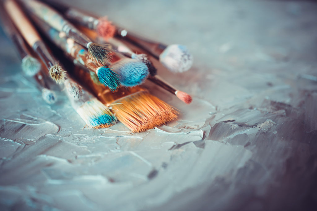Paintbrushes,On,Artist,Canvas,Covered,With,Oil,Paints
